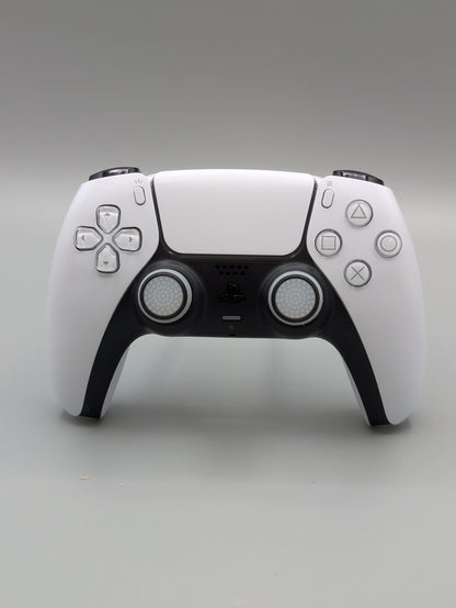 Custom PS5 controller showcasing the GOAT thumbstick toppers in white and black - front view