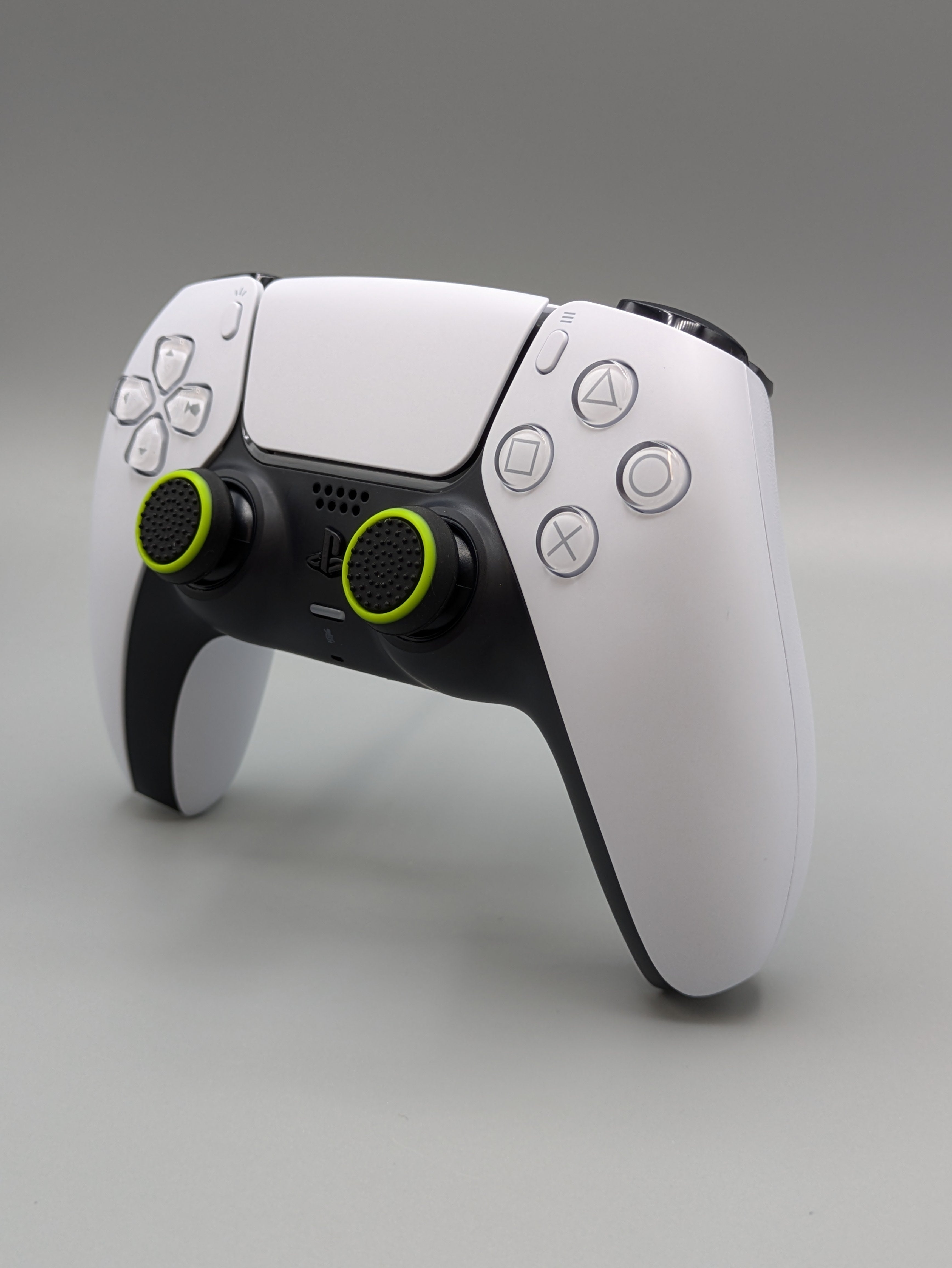 Custom PS5 controller showcasing the GOAT thumbstick toppers in black and yellow - side view