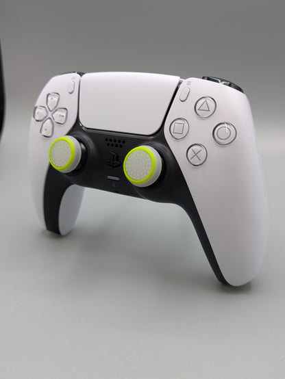 Custom PS5 controller showcasing the GOAT thumbstick toppers in white and yellow - side view