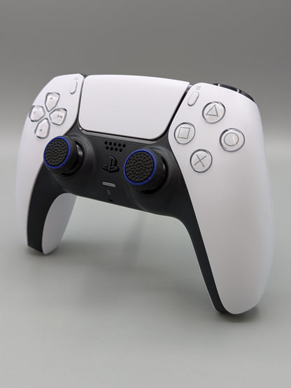 Custom PS5 controller showcasing the GOAT thumbstick toppers in black and blue - side view